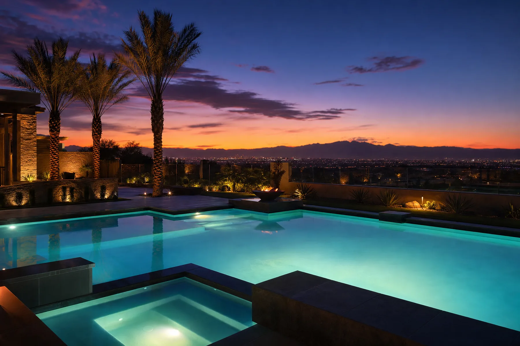 A Las Vegas pool glowing aqua at dusk with the valley lights beyond